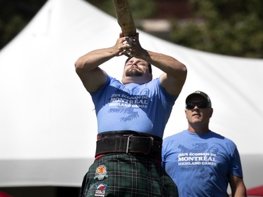 Competitors take part in the Caber Toss during the Montreal Highland games in Montreal on Sunday, July 31, 2022.