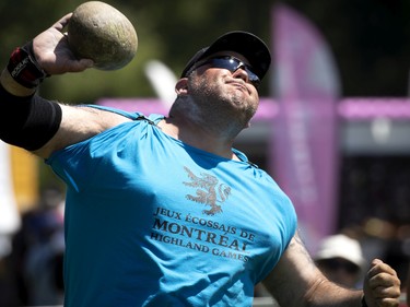 A competitor grimaces as he tosses a 17 pound stone in the stone put competition during the Montreal Highland games in Montreal on Sunday, July 31, 2022.