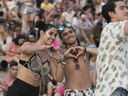 Lydia Shields and Michael Delima make a heart sign on day 2 of the Osheaga Music and Arts Festival at Parc Jean-Drapeau in Montreal Saturday, August 3, 2019. 
