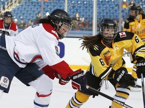 Kim Deschenes of Les Canadiennes battles for the puck with Boston's  Shannon Doyle in 2015. After years without a women's hockey team, Montreal is getting a PHF franchise for the 2022-23 season.
