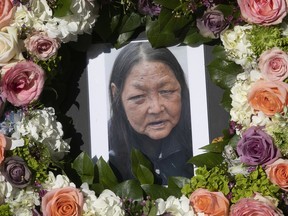 A crown of flowers surrounds the portrait of Elisapee Pootoogook during a tribute to her life at Cabot Square on Nov. 22, 2021. Pootoogook was found dead outside at the construction site of a luxury condominium on Nov. 12, 2021.