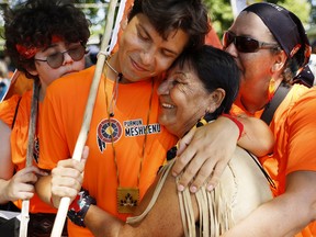 Jay Launière-Mathias and grandmother Thérèse Thelesh Bégin embrace after completing a 260-kilometre march from their Mashteuiatsh reserve to Quebec City for the visit of Pope Francis on Wednesday, July 27, 2022.