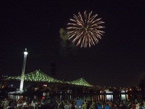 Fireworks go off above Jacques-Cartier Bridge