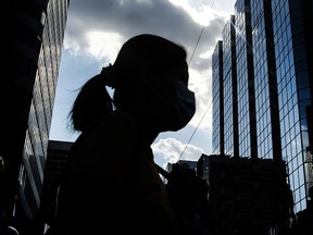 A pedestrian strolls through Toronto’s Yonge and Dundas area on July 19, 2022. SARS-CoV-2 may mutate into a mild version, but a catastrophic strain can’t be ruled out, says one expert.