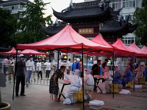 People line up to get tested for COVID-19 at a nucleic acid testing site in Shanghai, China July 12, 2022.