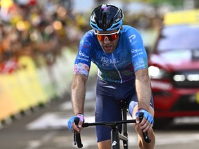 Israel-Premier Tech team's Canadian rider Hugo Houle cycles to the finish line of the 13th stage of the 109th edition of the Tour de France cycling race, 192,6 km between Le Bourg d'Oisans in the French Alps, and Saint-Etienne in central France, on July 15, 2022. (Photo by Anne-Christine POUJOULAT / AFP)