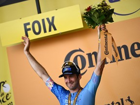 Israel-Premier Tech team's Canadian rider Hugo Houle celebrates on the podium after winning the 16th stage of the 109th edition of the Tour de France cycling race, 178,5 km between Carcassonne and Foix in southern France, on July 19, 2022.