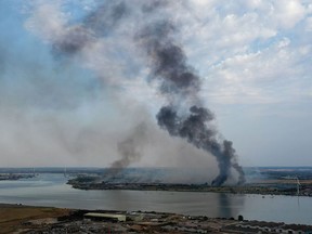 In this aerial view taken with a drone on Tuesday, smoke columns rise from Dartford, Kent, where a fire erupted earlier in the day as part of the consequences of an important heat wave scorching Britain.