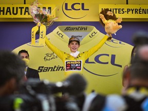 Jonas Vingegaard celebrates with the overall leader's yellow jersey on the podium after the 18th stage of the 109th edition of the Tour de France cycling race, 143,2 km between Lourdes and Hautacam in the Pyrenees mountains in southwestern France, on July 21, 2022.