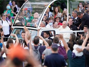 Pope Francis departs the Citadelle in the popemobile to greet crowds on the Plains of Abraham in Quebec City on July 27, 2022.