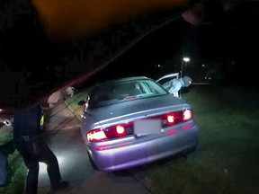 This image captured from a police officer's body camera and provided by the Akron Police Department on July 3, 2022, shows police surrounding the vehicle of 25-year-old Jayland Walker during a traffic stop in Akron, Ohio, on June 27, 2022.