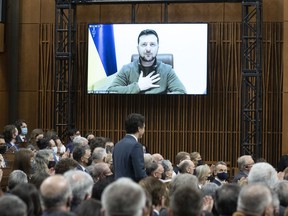 Ukrainian President Volodymyr Zelenskyy listens to Prime Minister Justin Trudeau before addressing Parliament back in March. Weren't we supposed to be his allies?