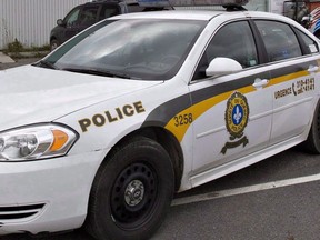 A Surete du Quebec police car is shown at the scene of a police search in St-Nicolas, a suburb of Levis, Que., on October 12, 2012. THE CANADIAN PRESS/Jacques Boissinot