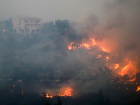 A wildfire burns in Ntrafi, Athens, Greece, July 19, 2022.