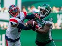 Montreal Alouettes defensive back Mike Jones (8) and Saskatchewan Roughriders wide receiver D'haquille Williams (5) battle for possession of the ball during first half CFL football action at Regina on Saturday July 2, 2022.