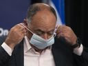 Quebec Health Minister Christian Dube puts on his mask after a press conference on COVID-19 in Montreal on July 7, 2022.