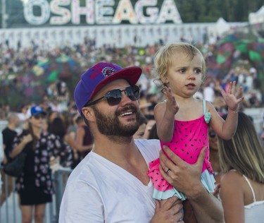 May McNaughton and dad Morgan enjoy the sounds on Day 1 of the Osheaga festival at Parc Jean-Drapeau in Montreal Friday, July 29, 2022.