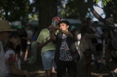 Jaime Velazquez (right) and Jeremiah Langdon found a nice light to take a selfie in on Day 1 of the Osheaga festival at Parc Jean-Drapeau in Montreal Friday, July 29, 2022.