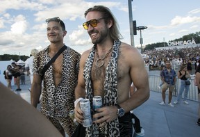 Jordan Curteanu (left) and Louis Retief from Vancouver enjoy the scene on Day 1 of the Osheaga festival at Parc Jean-Drapeau in Montreal Friday, July 29, 2022.