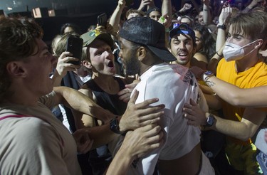 Future's DJ is mobbed by fans after diving from the stage into the crowd during Day 2 of the Osheaga festival on July 30, 2022.