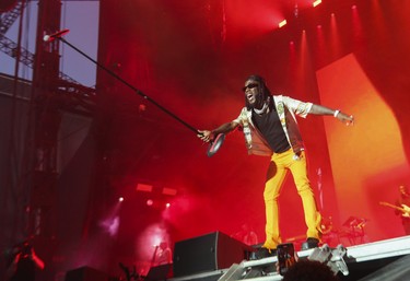 Artist Burna Boy holds up the microphone to the excited crowd on Day 2 of the Osheaga festival at Parc Jean-Drapeau in Montreal Saturday, July 30, 2022. (John Kenney / MONTREAL GAZETTE)