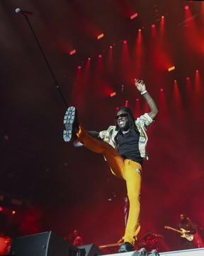 Artist Burna Boy holds up the microphone to the excited crowd on Day 2 of the Osheaga festival at Parc Jean-Drapeau in Montreal Saturday, July 30, 2022. (John Kenney / MONTREAL GAZETTE)