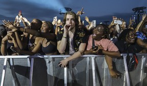 Excited fans, most of them anyways, watch the artist Burna Boy perform on Day 2 of the Osheaga festival at Parc Jean-Drapeau in Montreal Saturday, July 30, 2022. (John Kenney / MONTREAL GAZETTE)