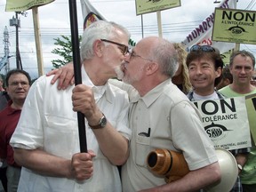 Theo Wouters (left) and Roger Thibault kiss while leading an anti-homophobia demonstration through the streets of Pointe-Claire on May 27, 2001.