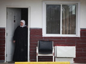 A woman with the ultra-Orthodox Jewish sect Lev Tahor steps out of her room at the Kent Motel in Chatham, Ont., in November 2013.