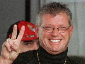 Maurice (Mom) Boucher, the reputed head of the Nomads chapter of the Hells Angels in Quebec, flashes peace sign to photographers outside a funeral home in Montreal where a wake for Normand 'Biff' Hamel was being held on Friday, April 21, 2000.