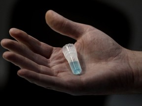 Blue preservation solution is shown at Spectrum DNA in Draper, Utah, April 3, 2020. Advances in DNA technology are being credited with solving a growing pile of cold case murders in the United States, but some Canadian police forces are lagging behind their U.S. counterparts in adopting it.