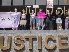 People take part in a protest against a decision by Judge Matthieu Poliquin in the case against a man who pleaded guilty to sexual assault and voyeurism in Montreal, Sunday, July 10, 2022.