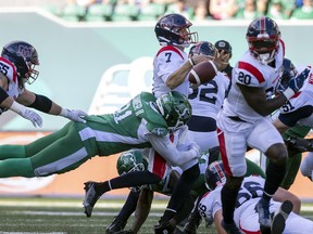 Saskatchewan Roughriders defensive lineman Anthony Lanier II (91) strips the ball from Montreal Alouettes quarterback Trevor Harris (7) during first half CFL action at Mosaic Stadium on Saturday , July 2, 2022 in Regina.