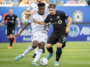 CF Montreal's Matko Miljevic, right, is challenged by Toronto FC's Deandre Kerr during first half MLS soccer action in Montreal, Saturday July 16, 2022.