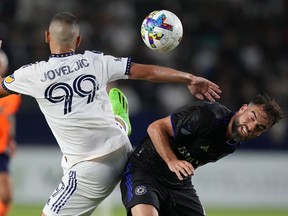 LA Galaxy forward Dejan Joveljic (99) and CF Montreal defender Rudy Camacho (4) battle for the ball in the first half at Dignity Health Sports Park on July 4, 2022.