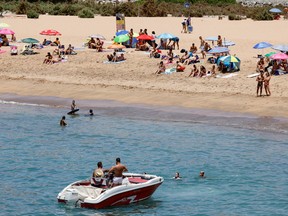 People enjoy a hot summer day at the Tauro beach on the island of Gran Canaria, Spain, July 17, 2022.