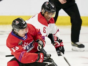 Team White defender Noah Warren of the Gatineau Olympiques battles Team Red’s Matthew Seminoff of the Kamloops Blazers during the second period of the 2022 Kubota CHL/NHL Top Prospects game in Kitchener, Ontario on Wednesday, March 23, 2022.