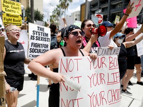 Abortion rights activists protest outside the venue of a summit by the conservative group 'Moms For Liberty' in Tampa, Florida, U.S. July 16, 2022.
