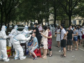Residents line up to be tested for COVID-19 in Wuhan, central China's Hubei province on Aug. 3, 2021.