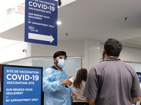 A greeter greets arrivals at the COVID-19 immunization center in Decalier Square in 2021.