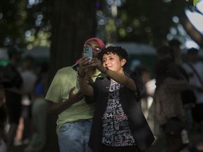 Jaime Velazquez (right) and Jeremiah Langdon found a nice light to take a selfie in on Day 1 of the Osheaga festival at Parc Jean-Drapeau in Montreal Friday, July 29, 2022.