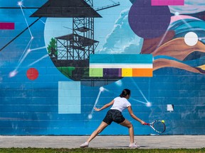 Tennis newbie Hekia Heyhani works of her technique against a municipal building on the Lachine Canal in Montreal on Tuesday August 2, 2022.