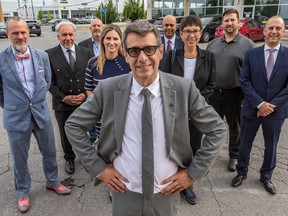 Conservative Party of Quebec Leader Eric Duhaime, centre, with eight of the nine Montreal-area candidates announced on Thursday. From left to right: Guy Diotte, Alex Tembel, Yves Beaulieu, Ève Théoret, Yassir Madih, Tzarevna Bratkova, Patric Viau and Gary Charles.