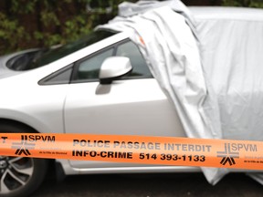 Police protect the scene after a man suspected of three homicides was shot dead by Montreal police Aug. 4, 2022.