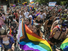 People march on Ste-Catherine St. in the Gay Village area of Montreal Sunday, Aug. 7, 2022. This was during a protest march that was made after the Pride Parade was cancelled.