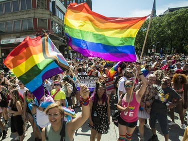 People march on Ste-Catherine St. in the Gay Village area of Montreal Sunday, Aug. 7, 2022. This was during a protest march that was made after the Pride Parade was cancelled.
