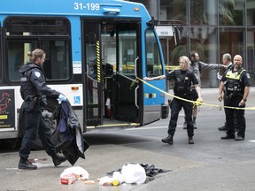 Montreal police officers at the scene of a collision involving a pedestrian that was hit by STM bus at the corner of Ste-Catherine and Guy Sts. on Monday Aug. 8, 2022.