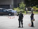 Montreal police examine a crime scene at Lester B. Pearson High School in Montreal North Aug. 11, 2022.