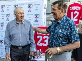 Former Montreal Canadiens and Team Canada teammates Guy Lapointe and Serge Savard, right, chat at the thirrd edition of the Serge Savard Invitational golf tournament at Le Mirage golf club in Terrebonne on Aug. 16, 2022.
