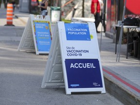 Signs advertising a mobile vaccination clinic in Place des Festivals operated by the CIUSSS Centre-Sud de Montréal on Aug. 8, 2021